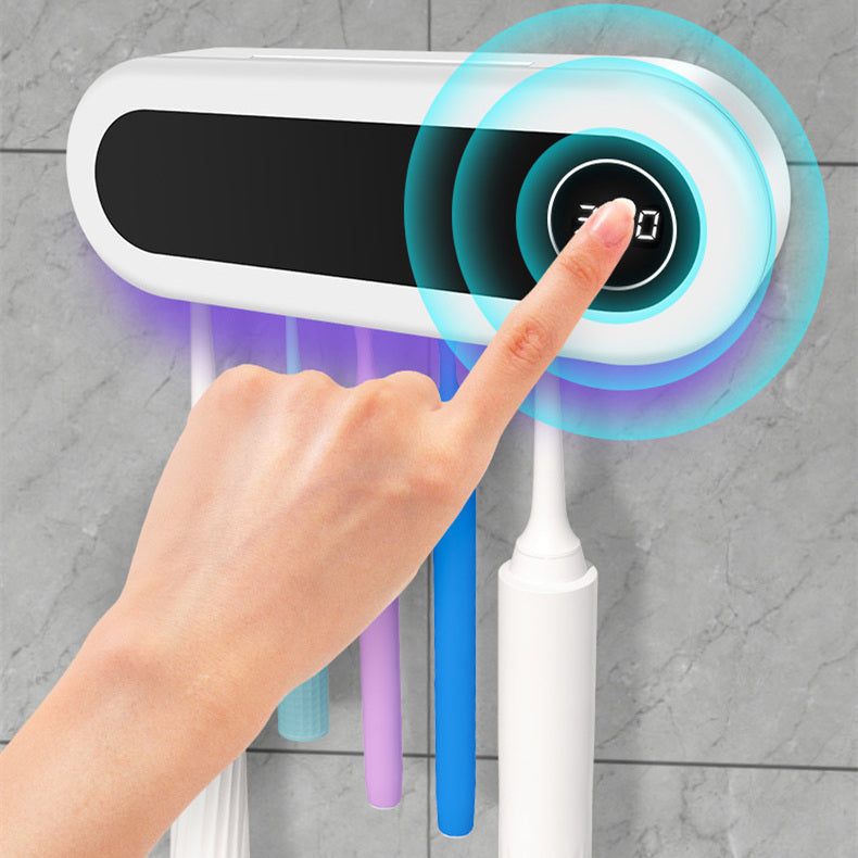 Wall-mounted toothbrush holder with a smart UV sterilizer, toothpaste dispenser, and squeezer, perfect for bathroom accessories.