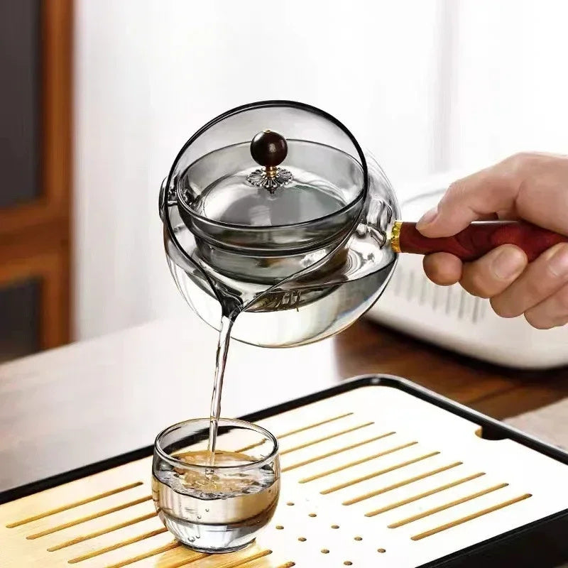 Semi-automatic rotary heat-resistant glass teapot with an infuser and wooden handle, perfect for effortless tea making. A stylish accessory for both office and home, blending functionality and elegance in your kitchen gadgets.