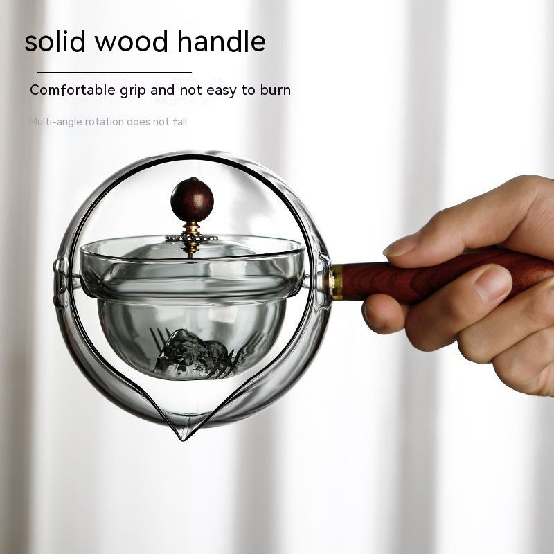 Semi-automatic rotary heat-resistant glass teapot with an infuser and wooden handle, perfect for effortless tea making. A stylish accessory for both office and home, blending functionality and elegance in your kitchen gadgets.