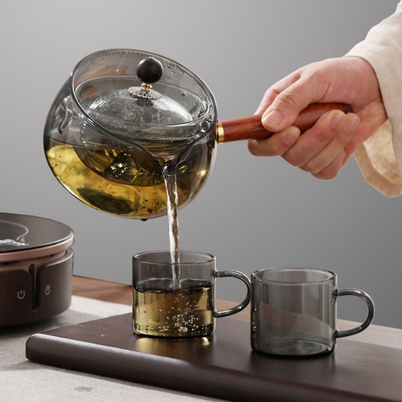 Semi-automatic rotary heat-resistant glass teapot with an infuser and wooden handle, perfect for effortless tea making. A stylish accessory for both office and home, blending functionality and elegance in your kitchen gadgets.