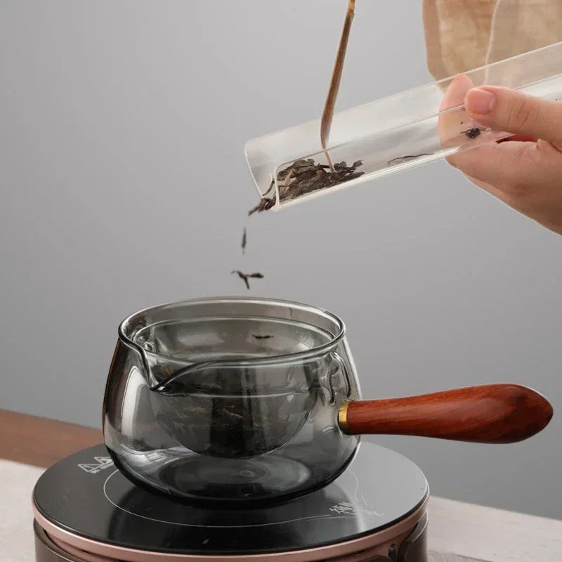 Semi-automatic rotary heat-resistant glass teapot with an infuser and wooden handle, perfect for effortless tea making. A stylish accessory for both office and home, blending functionality and elegance in your kitchen gadgets.